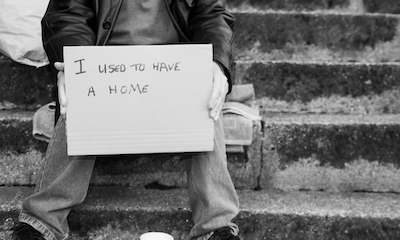 Homeless man with sign saying I used to have a home